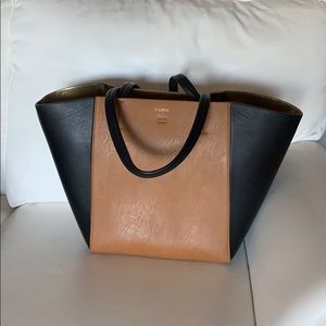 Bebe Black & Tan Handbag With small blemish on black side panel.